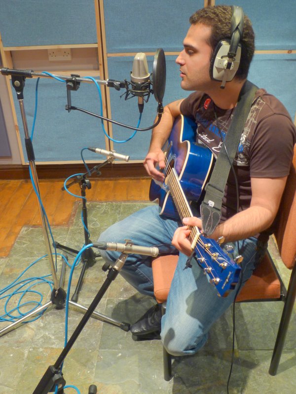 Singer Songwriter miked up ready to record A singer songwriter mic'ed up and ready to record.